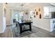 Charming dining area featuring modern decor, stylish lighting, and seamless access to the kitchen and outdoor patio at 2801 21St W Ave, Bradenton, FL 34205
