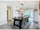 Bright dining room featuring a wood table, modern light fixture, and sliding glass doors to outdoor space at 2801 21St W Ave, Bradenton, FL 34205