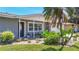 Close up of the home's front entry, emphasizing lush tropical landscaping, a cozy bench, and a welcoming doorway at 2801 21St W Ave, Bradenton, FL 34205