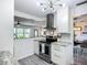 Stylish kitchen with stainless steel appliances, white cabinets, and view to living room at 2801 21St W Ave, Bradenton, FL 34205