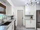 Well-lit kitchen featuring white cabinets, granite countertops, and stainless steel appliances at 2801 21St W Ave, Bradenton, FL 34205