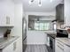 Contemporary kitchen featuring stainless steel appliances, white cabinets, and an open layout at 2801 21St W Ave, Bradenton, FL 34205