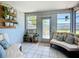 Bright sunroom featuring cozy seating, tile floors, many windows and hanging plants at 2801 21St W Ave, Bradenton, FL 34205