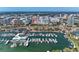 Breathtaking aerial view of a marina with multiple boats and a city skyline in the background on a sunny day at 33 S Gulfstream Ave # 306, Sarasota, FL 34236