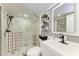 Modern bathroom features a glass enclosed shower, floating shelves and updated fixtures and sink at 33 S Gulfstream Ave # 306, Sarasota, FL 34236