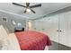 Comfortable bedroom features dark floors, ceiling fan, a large closet, and a calming gray wall at 33 S Gulfstream Ave # 306, Sarasota, FL 34236