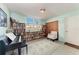 Cozy room with a wall of bookshelves, a piano, and a comfortable chair at 33 S Gulfstream Ave # 306, Sarasota, FL 34236