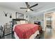 Comfortable bedroom with dark floors, ceiling fan, unique decor, and a comfortable bed with plush bedding at 33 S Gulfstream Ave # 306, Sarasota, FL 34236