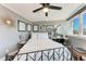 Well-lit bedroom features a ceiling fan, modern decor, and a comfortable bed with white linens at 33 S Gulfstream Ave # 306, Sarasota, FL 34236