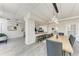 Open-concept dining area with a large wooden table, modern lighting, and easy access to the kitchen and living space at 33 S Gulfstream Ave # 306, Sarasota, FL 34236