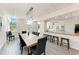 Bright dining area featuring modern lighting, a large table, and a breakfast bar at 33 S Gulfstream Ave # 306, Sarasota, FL 34236