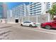 White mid-rise building with covered parking behind decorative concrete wall at 33 S Gulfstream Ave # 306, Sarasota, FL 34236