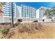 Modern condo exterior featuring a white facade, secure parking, and low-maintenance landscaping at 33 S Gulfstream Ave # 306, Sarasota, FL 34236