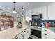 Bright kitchen features white cabinetry, stainless appliances, and plenty of counter space at 33 S Gulfstream Ave # 306, Sarasota, FL 34236