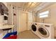 Basement laundry room includes washer, dryer, utility sink, and functional door to mechanical room at 33 S Gulfstream Ave # 306, Sarasota, FL 34236