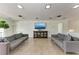 Spacious living room featuring modern sofas, tile floors, and a large TV at 33 S Gulfstream Ave # 306, Sarasota, FL 34236