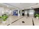 Modern lobby with tiled floors, plants, seating and elevator access for a luxurious entrance at 33 S Gulfstream Ave # 306, Sarasota, FL 34236