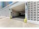 Parking garage entrance with decorative concrete blocks, security, and covered parking at 33 S Gulfstream Ave # 306, Sarasota, FL 34236