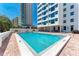 Inviting community pool with brick-lined edge and lounge chairs for relaxation at 33 S Gulfstream Ave # 306, Sarasota, FL 34236