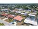 Aerial view of the home showcasing its red tile roof, blue driveway, and mature landscaping at 3426 Brookline Dr, Sarasota, FL 34239