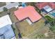 Aerial view of backyard with concrete paver patio; home has red tile roof and fenced yard at 3426 Brookline Dr, Sarasota, FL 34239