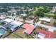 Aerial view of home with a red tile roof and blue driveway, set in a neighborhood at 3426 Brookline Dr, Sarasota, FL 34239