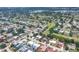 Expansive aerial view of the neighborhood featuring lush greenery and a golf course in the distance at 3426 Brookline Dr, Sarasota, FL 34239