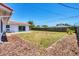 Expansive backyard with a well-kept lawn, defined mulch areas, and a sturdy wooden fence ensuring privacy at 3426 Brookline Dr, Sarasota, FL 34239