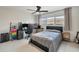 Bright bedroom featuring a ceiling fan, neutral walls, and a large window for natural light and a built-in desk at 3426 Brookline Dr, Sarasota, FL 34239