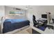 Well-lit bedroom featuring a ceiling fan, large window, and spacious closet at 3426 Brookline Dr, Sarasota, FL 34239
