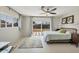 Bright bedroom with a ceiling fan, patterned rug and sliding door access to backyard at 3426 Brookline Dr, Sarasota, FL 34239