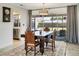 View of elegant dining room with wooden table and chairs, plus sliding doors to screened patio at 3426 Brookline Dr, Sarasota, FL 34239
