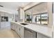 Well-equipped kitchen featuring white cabinetry, stainless steel appliances, and a large window at 3426 Brookline Dr, Sarasota, FL 34239