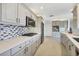Modern kitchen with gray cabinets, stainless steel appliances, and tile backsplash at 3426 Brookline Dr, Sarasota, FL 34239