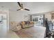 Bright living room with ceiling fan, comfortable seating, and view to outdoor patio at 3426 Brookline Dr, Sarasota, FL 34239