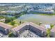 Scenic aerial view of a condo complex with beautiful lake, lush greenery, community tennis court, and swimming pool at 3521 Lake Bayshore Dr # 3521, Bradenton, FL 34205