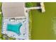 Aerial shot of a lakefront community showcasing a pool, pier, and sun loungers for relaxation at 3521 Lake Bayshore Dr # 3521, Bradenton, FL 34205