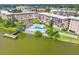 An aerial shot of a condo community showing the pool, fishing pier and mature landscaping at 3521 Lake Bayshore Dr # 3521, Bradenton, FL 34205