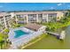 Beautiful aerial showcasing the pool, pier, and surrounding buildings of a lakefront community at 3521 Lake Bayshore Dr # 3521, Bradenton, FL 34205