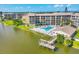 Aerial view capturing a lakeside community, swimming pool, pier, landscaping and multi-story condos at 3521 Lake Bayshore Dr # 3521, Bradenton, FL 34205