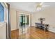 Bedroom features hardwood floors, ceiling fan, and sliding glass doors at 3521 Lake Bayshore Dr # 3521, Bradenton, FL 34205