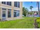 Exterior view of the condo building featuring well-maintained lawns and beautiful landscaping at 3521 Lake Bayshore Dr # 3521, Bradenton, FL 34205