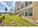 Scenic view of condo building exterior with well-maintained lawns, landscaping, and lake views at 3521 Lake Bayshore Dr # 3521, Bradenton, FL 34205