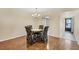 Dining room with chandelier, hardwood floors, and four upholstered chairs at 3521 Lake Bayshore Dr # 3521, Bradenton, FL 34205