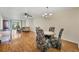 Dining area with wood floors, chandelier, and living room in the background at 3521 Lake Bayshore Dr # 3521, Bradenton, FL 34205