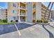 Multi-story condo building with assigned parking space, well-maintained landscaping, and private balconies overlooking the property at 3521 Lake Bayshore Dr # 3521, Bradenton, FL 34205