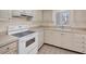 Clean and bright kitchen featuring white cabinetry, modern appliances, tile flooring, and a large window for natural light at 3521 Lake Bayshore Dr # 3521, Bradenton, FL 34205