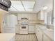 Bright kitchen features white appliances, tile floor, and ample counter space at 3521 Lake Bayshore Dr # 3521, Bradenton, FL 34205
