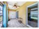 Lanai featuring tile flooring, ceiling fan, and a sliding glass door to the home's interior at 3521 Lake Bayshore Dr # 3521, Bradenton, FL 34205