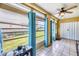 Enclosed Lanai featuring tile flooring, ceiling fan, and large windows with backyard views at 3521 Lake Bayshore Dr # 3521, Bradenton, FL 34205